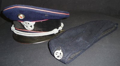 Lot 156 - A German Third Reich Fire Official NCO's Peaked Cap, in dark blue cloth with pink piping, black...