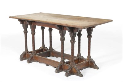 Lot 1248 - A Gothic Revival 5' Oak Table, single plank top, with a carved frame with alternating entwined...