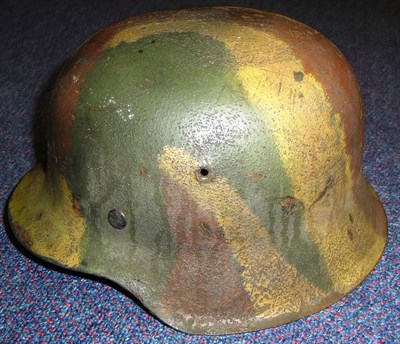 Lot 162 - A German Third Reich M42 Helmet, with camouflage paint, green painted interior, with aluminium...