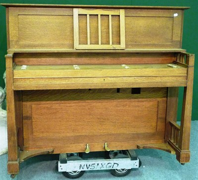 Lot 1250 - An Arts and Crafts Oak Upright Piano, possibly by Brooklands Piano Co., in the manner of...