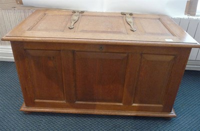 Lot 1254 - A Modern Arts and Crafts Panelled Oak Blanket Box, with strap brass hinges, on four turned...