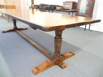 Lot 1257 - A Modern 10' Oak Refectory Table, made by G William Rowlatt, the plank top on two turned legs...