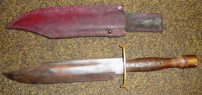 Lot 265 - A Bowie Type Knife, with hatchet tip steel blade, brass crossguard and red stained wood grip...