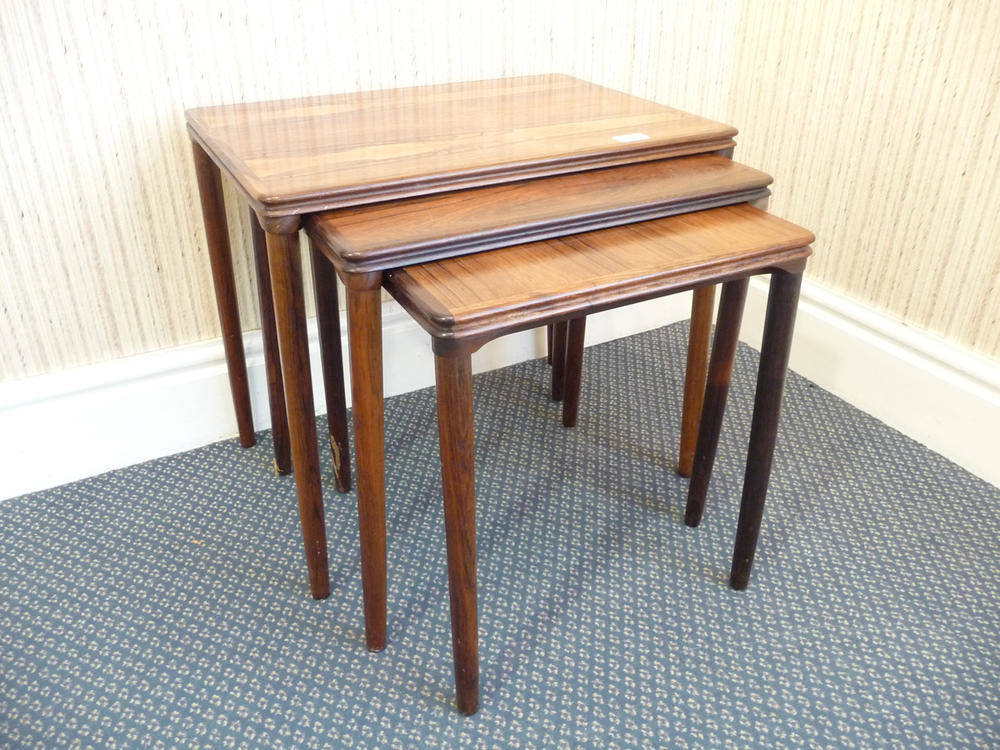 Lot 1260 - A 1960's Danish Rosewood Nest of Tables, with moulded edge on four circular tapering legs, each...