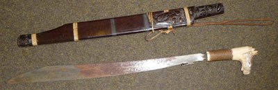 Lot 325 - A Dyak, Borneo Mandau (Head Hunter's Sword), with 50cm single edge broad steel blade, the bone hilt