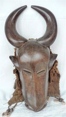 Lot 340 - A Bamileke Buffalo Mask, with pierced eyes, nose and mouth, with woven vegetable fibre neck...