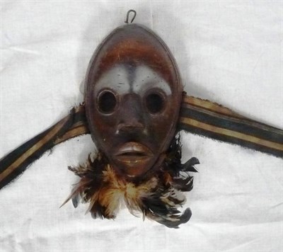 Lot 341 - A Dan Mask, the oval face with domed forehead, circular pierced eyes, flared nostrils and...