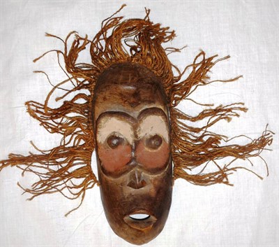 Lot 346 - A Lega Mask, the concave oval face with goggle eyes on a ground painted in cream and ochre...