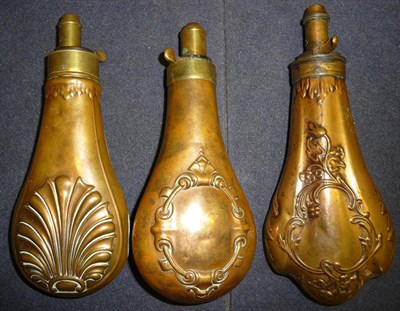 Lot 393 - Three Copper Powder Flasks, with embossed decoration of a shell, strapwork cartouche and...