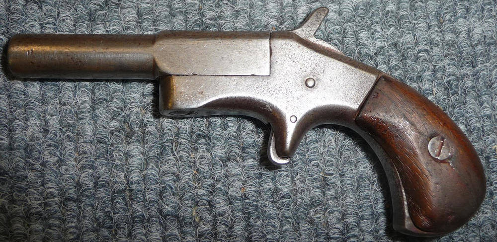 Lot 462 - An America Rimfire Deringer Pistol, with 7cm hinged and side swivel steel barrel, sheath...