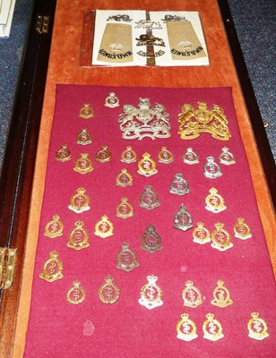 Lot 93 - A Glazed Display to the Royal Army Medical Corps, containing an Officer's brass helmet plate, an OR