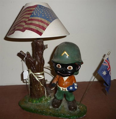 Lot 100 - An Amusing Painted Plaster Figural Table Lamp, modelled as caricature negro US Marine standing...