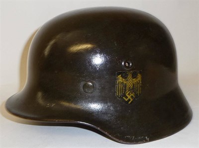 Lot 206 - A German Third Reich M35 Army Helmet, with single decal, rolled edge, the inner brim stamped...