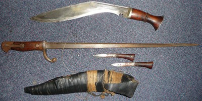 Lot 270 - A Ghurka Kukri, the plain curved blade with narrow fuller to the top edge, ringed wood grip...