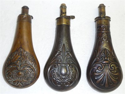 Lot 376 - Three Copper Powder Flasks, of pear shape, one embossed with a stylised shell, the brass...