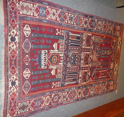 Lot 1335 - Shirvan Rug East Caucasus The claret field depicting a mosque with panels of octagons above and...