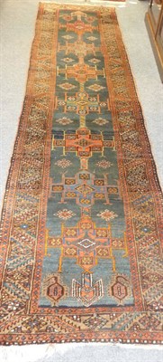 Lot 1336 - Narrow North West Persian Runner The shaded indigo ground with a column of cruciform medallions...