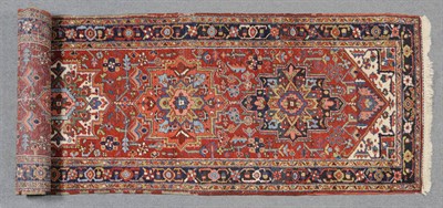 Lot 1337 - Narrow Heriz Runner Persian Azerbaijan The madder field with five polychrome medallions framed...