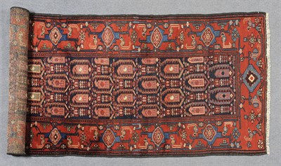 Lot 1339 - Hamadan Runner Persian Kurdistan The indigo field with a lattice containing boteh enclosed by...