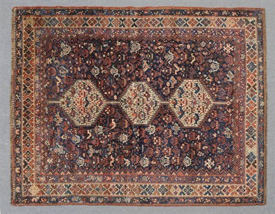 Lot 1340 - Khamseh Rug South West Persia The deep indigo field with three ivory stepped medallions...