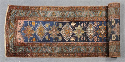 Lot 1342 - Narrow Heriz Runner Persian Azerbaijan The shaded indigo field with a single column of latch...