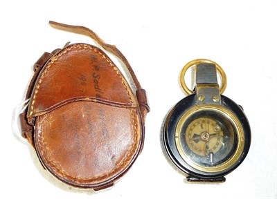 Lot 154 - A Barker's Patent Black Enamelled Brass Pocket Compass, the back stamped with broad arrow...