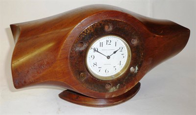 Lot 159 - A Teak Mantel Timepiece, made from the hub of a laminated propeller blade, the circular cream...