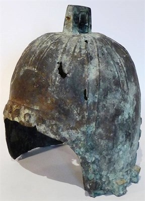 Lot 170 - A Chinese Western Zhou Style Bronze Helmet, with angular lug to the panelled crown, 31cm high.