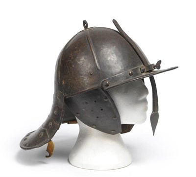 Lot 187 - A Cromwellian Lobster Tail Helmet, the one piece skull with six ribbed panels, adjustable nasal...