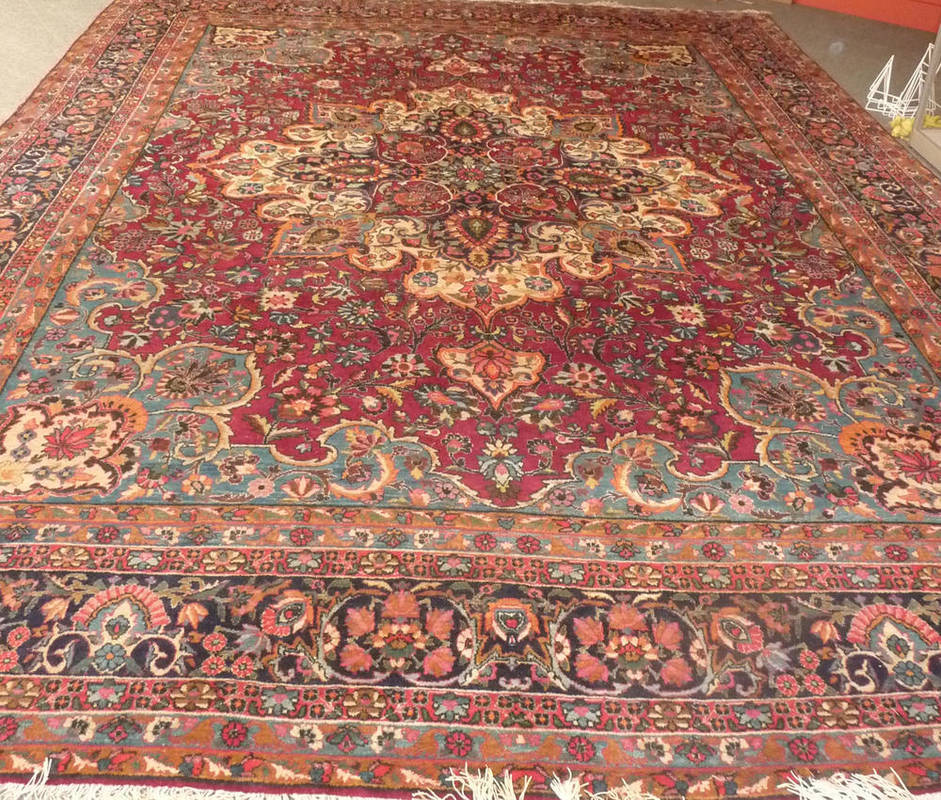 Lot 1350 - Yazd Carpet South East Persia The raspberry field of flowering vines around a large floral...