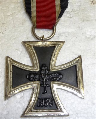 Lot 215 - A German Third Reich Iron Cross, Second Class, the iron centre panel worked with triple oak...