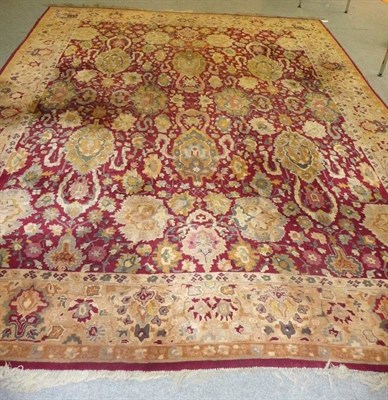 Lot 1355 - Eastern European Carpet of Agra Design The raspberry field within an allover design of large...