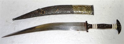 Lot 324 - An Arab Jambiya, the double edge curved steel blade engraved with feathered leaves, the horn...