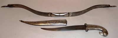 Lot 326 - An Indian Dagger, with curved steel blade, the parrot head hilt and scabbard inlaid with silver...