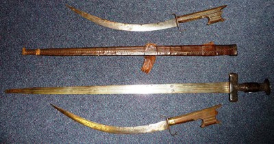 Lot 327 - A Tuareg Sword, the 73cm double edge steel blade with three narrow fullers to each side, the...