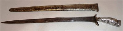 Lot 334 - A Malayan/Javanese Badik Type Knife, with foliate chased silver coloured metal pistol grip and...