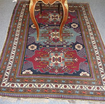 Lot 1364 - Derbend Rug East Caucasus The indigo field with three polychrome cruciform medallions flanked...