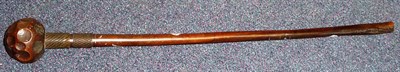 Lot 344 - A Zulu Knobkerrie, the globular head with dimple carved decoration, the tapering cylindrical...