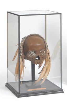 Lot 346 - An Asmat Ancestor Skull, Irian Jaya, Indonesia, circa 1900, the eye sockets filled with beeswax and