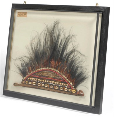 Lot 347 - An Asmat, Irian Jaya, Indonesia Headdress, of woven vegetable fibre applied with cowrie shells,...