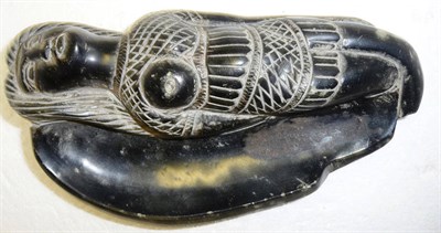 Lot 348 - An Inuit Black Soapstone Figural Dish, worked as a reclining mermaid, her tail forming the...