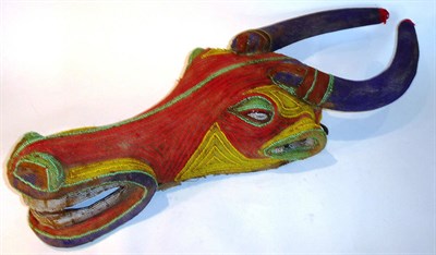 Lot 368 - A Cameroon Buffalo Dance Mask, the large heavy wood frame covered in coloured glass beads, 99cm