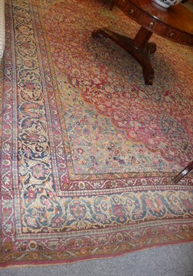 Lot 1367 - Ravar Kirman Carpet South East Persia The claret field with flowering vines centred by an...