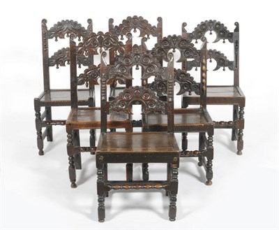 Lot 1400 - A Harlequin Set of Six Oak Back Stools, probably South Yorkshire, the elaborately carved top...