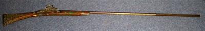 Lot 517 - A 19th Century Eastern Miquelet Lock Long Gun, with 123cm octagonal steel barrel, wood half...