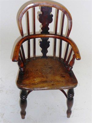 Lot 1404 - A Mid 19th Century Child's Yewwood Windsor Chair, the low splat back between upright spindles...