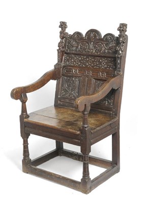 Lot 1409 - A Joined Oak Armchair, 17th century and later, the back support with a shaped top rail above flower