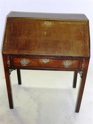 Lot 1411 - A George III Oak Bureau on Stand, late 18th century, the crossbanded fall enclosing pigeon...