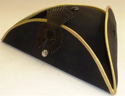 Lot 104 - A Chelsea Pensioner's Tricorn Hat, in black wool felt with gold piping, leather cockade and...