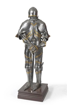 Lot 114 - A Reproduction Suit of Armour, in the Gothic style, with arcaded brass trim, close helmet and broad